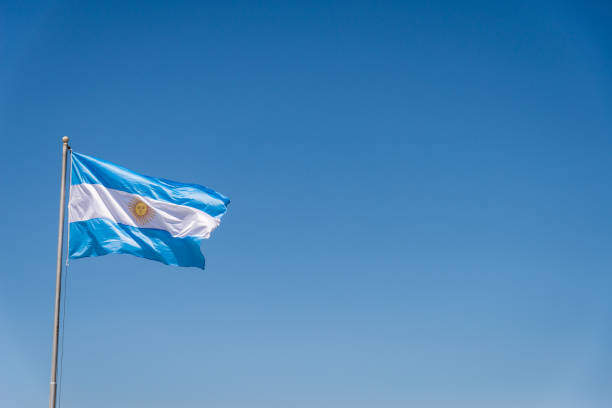 Argentinian flag waving against blue sky on a sunny day stock photo