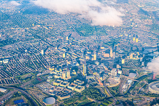 Aerial high angle above bird's eye view from airplane over Stratford city in London in United Kingdom with terraced houses buildings and cityscape skyscrapers