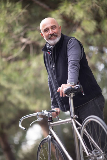 istock Portrait of senior man with bicycle 1220859811