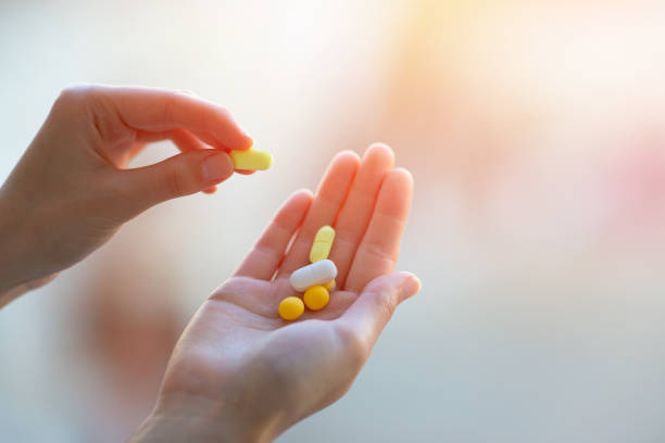 istock A Handful Of Colored Pills On A Female Hand 1220863104