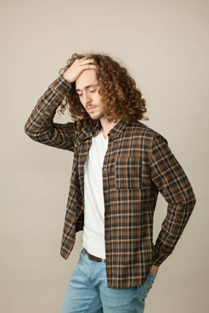 istock studio portrait of a young man with a beard on a beige background 1220863355