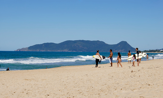 April 16, 2020. Surfers and people at Praia do Campeche Florianópolis, Santa Catarina, Brazil.