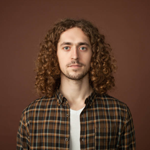istock studio portrait of a young man with a beard on a brown background 1220865754