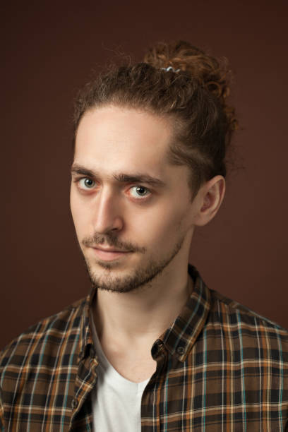 istock studio portrait of a young man with a beard on a brown background 1220865755
