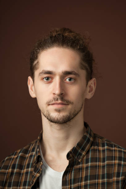 istock studio portrait of a young man with a beard on a brown background 1220865979