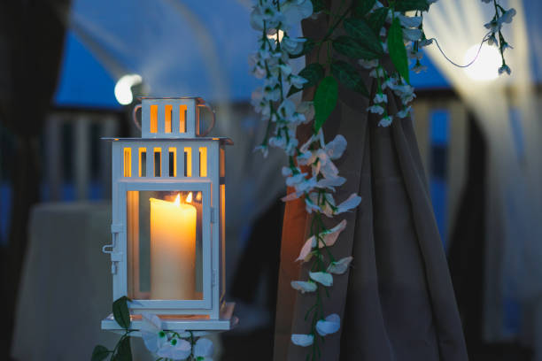 istock Beautiful white candlestick with a burning candle in the late evening 1220866304