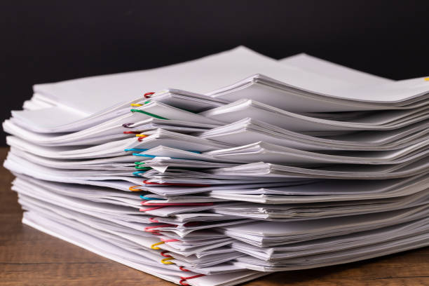 istock Stack overload document report paper with colorful paperclip place and copy space on black background, business concept footage paperless used 1220868568