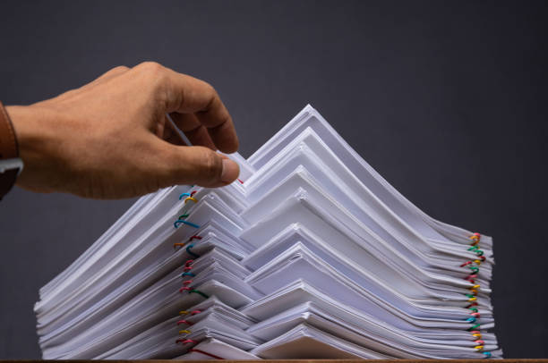 istock Hand pick up Stack overload document report paper with colorful paperclip place and copy space, business concept footage paperless used 1220868582