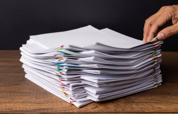 istock Hand pick up Stack overload document report paper with colorful paperclip place and copy space, business concept footage paperless used 1220868597
