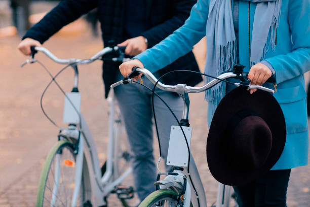 istock Couple Riding Bicycles: Hands Holding Handlebars 1220868612