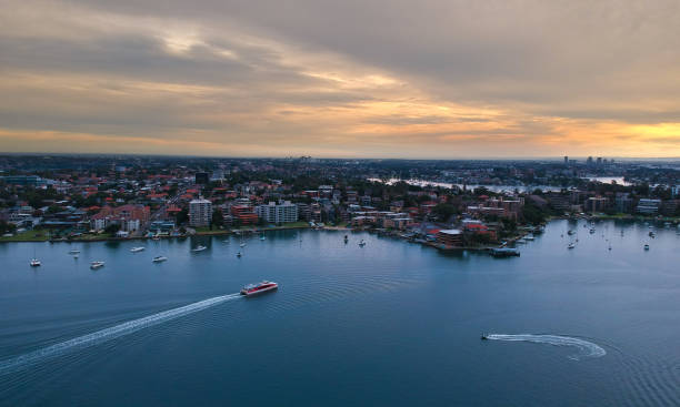 istock Panoramic drone aerial view over Sydney harbour on a cloudy sunset showing the nice colours of the harbour foreshore 1220871282