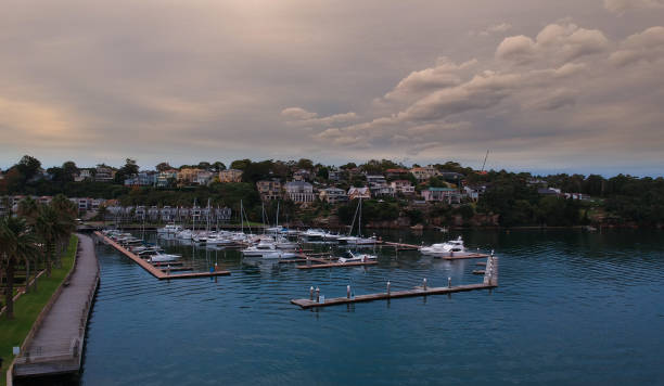 istock Panoramic drone aerial view over Sydney harbour on a cloudy sunset showing the nice colours of the harbour foreshore 1220871284