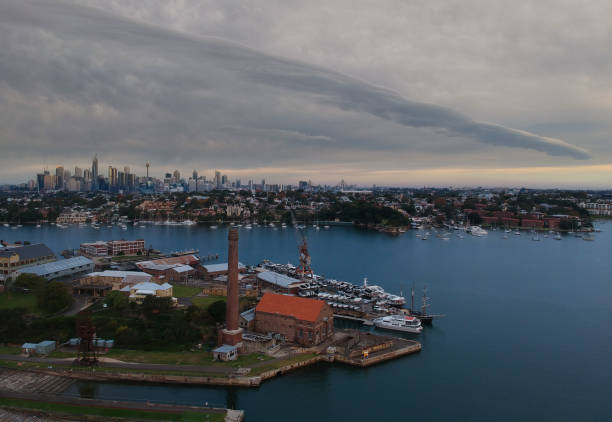 istock Panoramic drone aerial view over Sydney harbour on a cloudy sunset showing the nice colours of the harbour foreshore 1220871288