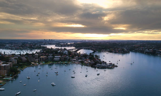istock Panoramic drone aerial view over Sydney harbour on a cloudy sunset showing the nice colours of the harbour foreshore 1220871289