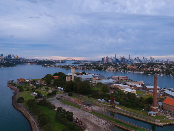istock Panoramic drone aerial view over Sydney harbour on a cloudy sunset showing the nice colours of the harbour foreshore 1220871290
