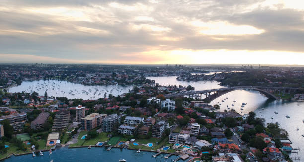 istock Panoramic drone aerial view over Sydney harbour on a cloudy sunset showing the nice colours of the harbour foreshore 1220871292