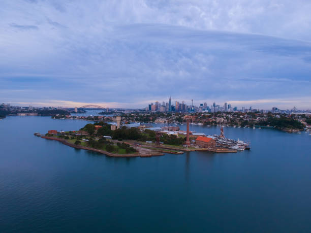 istock Panoramic drone aerial view over Sydney harbour on a cloudy sunset showing the nice colours of the harbour foreshore 1220871297
