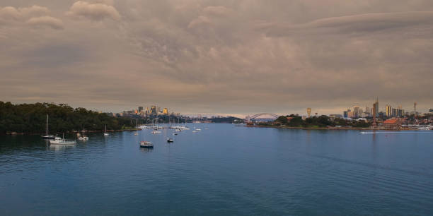 istock Panoramic drone aerial view over Sydney harbour on a cloudy sunset showing the nice colours of the harbour foreshore 1220871301