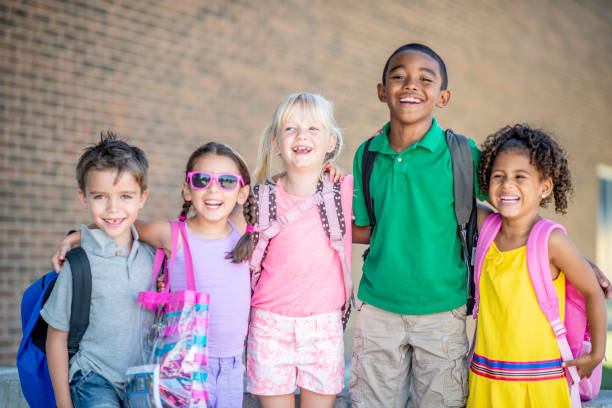 istock Group of kids in front of school 1220873163