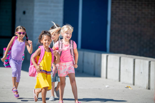 istock Group of kids in front of school 1220873167