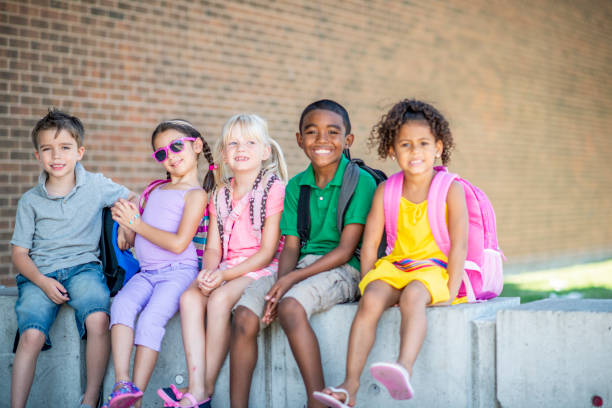 istock Group of kids in front of school 1220873172