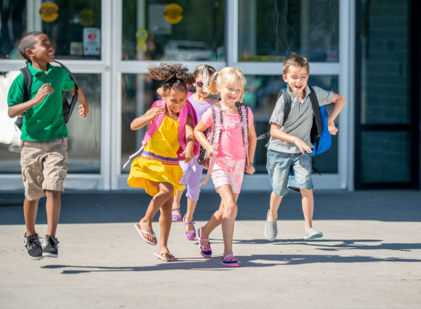 istock Group of kids in front of school 1220873176
