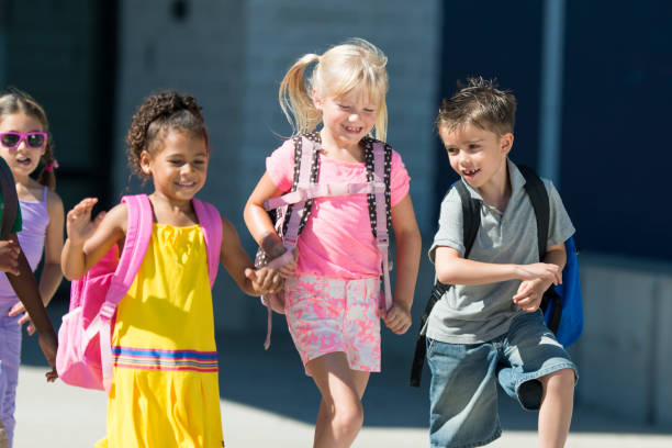 istock Group of kids in front of school 1220873180