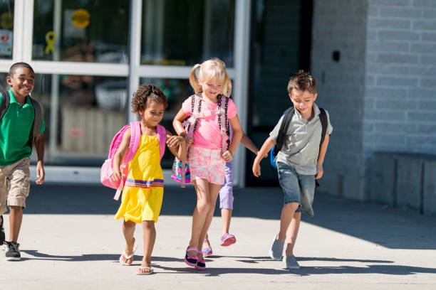istock Group of kids in front of school 1220873182