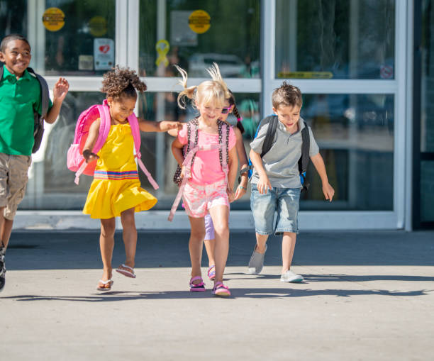 istock Group of kids in front of school 1220873184