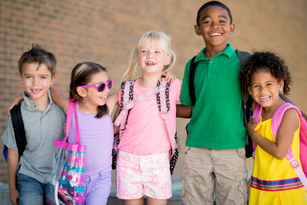 istock Group of kids in front of school 1220873185