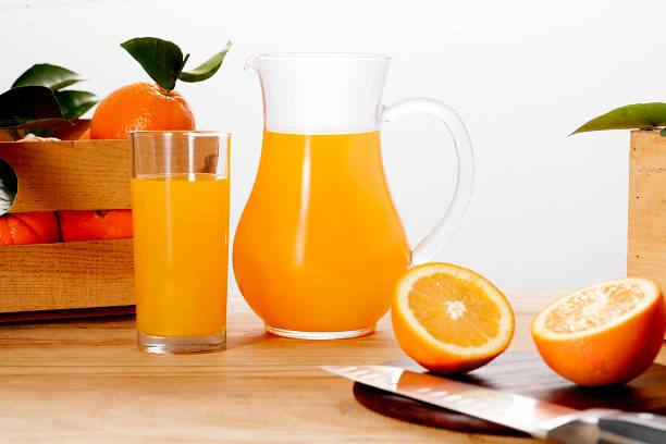 istock Pitcher and glass of orange juice with fresh oranges. 1220873225