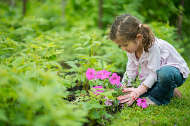 istock Cute young girl gardening outside 1220873330
