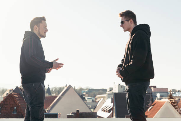 istock Conflict and Discussion Young Men On City Rooftop 1220875096