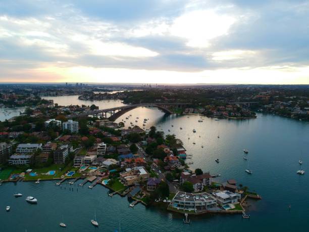 istock Panoramic drone aerial view over Sydney harbour on a cloudy sunset showing the nice colours of the harbour foreshore 1220876865