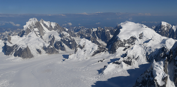 Mooses Tooth (on the left) and Mt Dickey (white triangle) on the right. Small planes are visible at full size, on a landing strip located just below Mt Barrille (smaller triangle mountain) in between the two mentioned above. This is where the Great Gorge and the Ruth Glacier start, out of a massive Don Sheldon Amphitheater, covered with snow.