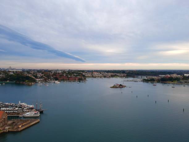istock Panoramic drone aerial view over Sydney harbour on a cloudy sunset showing the nice colours of the harbour foreshore 1220876999