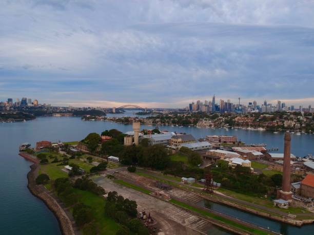 istock Panoramic drone aerial view over Sydney harbour on a cloudy sunset showing the nice colours of the harbour foreshore 1220877008