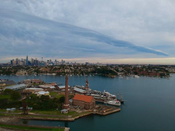 istock Panoramic drone aerial view over Sydney harbour on a cloudy sunset showing the nice colours of the harbour foreshore 1220877016