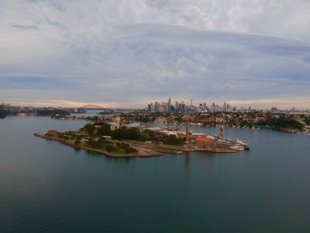 istock Panoramic drone aerial view over Sydney harbour on a cloudy sunset showing the nice colours of the harbour foreshore 1220877025