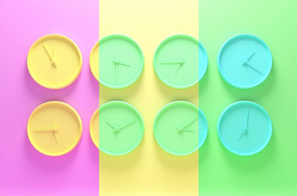 istock Multi colored abstract image with a few wall clocks showing different time. 3D illustration 1220884153