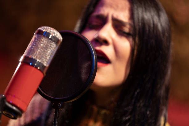 istock Famele singer performing for recording in sound studio 1220886801