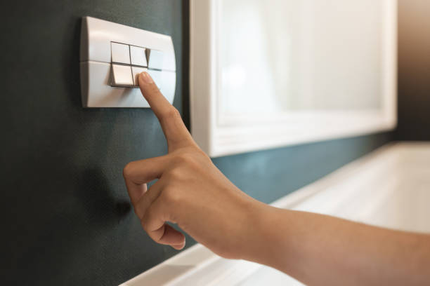 Close up of finger is turning off on light switch over green wall at the hotel. Close up of finger is turning off on light switch over green wall at the hotel. Copy space. light switch photos stock pictures, royalty-free photos & images