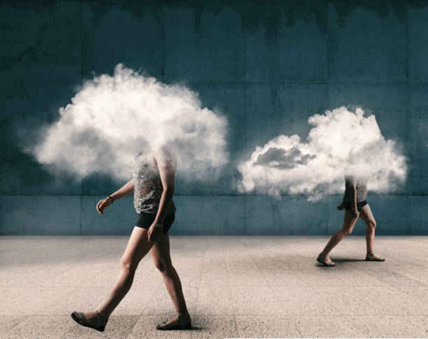 istock People walking outdoor with the head inside a cloud . Mental illness concept. 1220889276