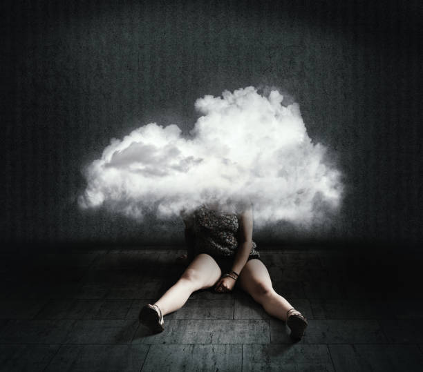 istock Sad woman sits down with the head inside a cloud . Mental illness concept. 1220889299