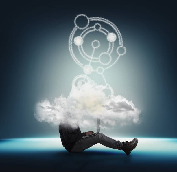 istock Businessman working on lapton with head into a cloud . Network and cloud storage concept . Team working online . 1220889319