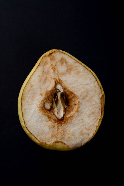istock cut out section of an overripe pear on black background 1220889489