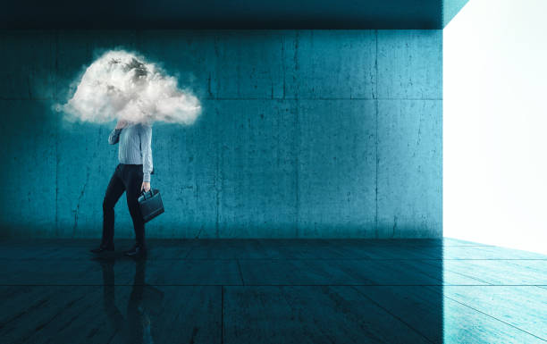 istock Businessman walking on a modern blue background with a his head in a cloud. 1220890023