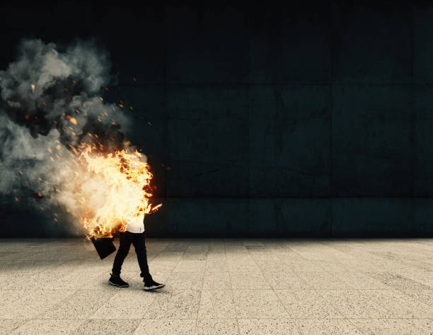 istock Burning businessman going to work . Life insurance concept . Work assurance . Careless worker going to work while on fire . 1220890091