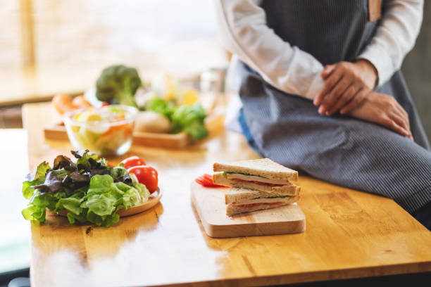 istock a female chef finish cooking whole wheat sandwich in kitchen 1220890150