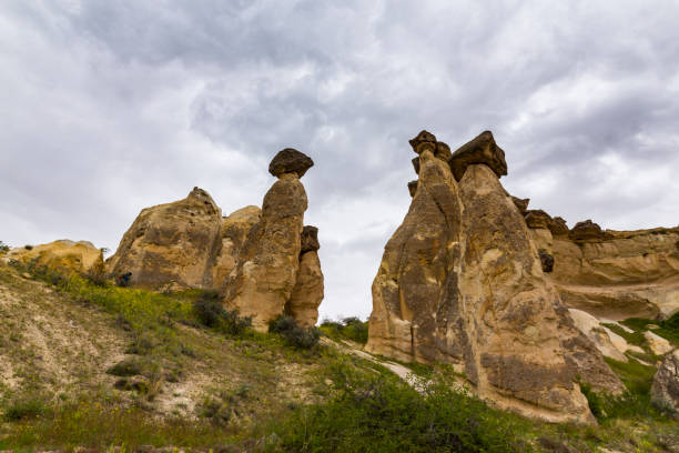 Beautiful sandstone rock formations in Cappadocia, Goreme, Turkey, under dramatic stormy sky Beautiful sandstone rock formations in Cappadocia, Goreme, Turkey Goreme stock pictures, royalty-free photos & images